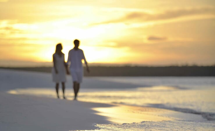 Family safari specialists - Mike and Tess walking andbeyond mnemba island Zanzibar sunset