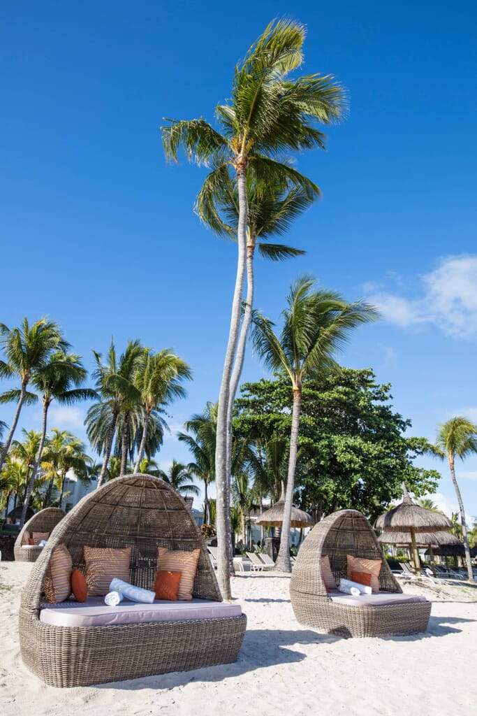 North Coast – Known for its lively beaches and clear waters, Mauritius’ North Coast is a must for family holidays. This bustling region offers a range of activities, from water sports like snorkelling and diving to exploring vibrant markets in Grand Baie and day trips to nearby uninhabited islands. Families can also enjoy popular beaches like Grand Baie and Pereybere, where the calm waters are perfect for children. East Coast – Nestled along the island’s wilder, more untouched coastline, the East Coast offers a secluded and peaceful escape. Ideal for families seeking tranquillity, this area boasts some of Mauritius’ most beautiful beaches, such as Belle Mare, known for its long stretches of white sand. Families can enjoy quiet lagoons, private boat trips, and nature walks through the Domaine de l’Etoile. South Coast – As Mauritius’ most rugged and untamed coastline, the South Coast is ideal for families seeking adventure. With dramatic cliffs, lush landscapes, and natural reserves like Bel Ombre, the South offers a wilder experience. Families can explore waterfalls, hike through scenic trails, and visit the famous Chamarel Seven Coloured Earths. The South Coast is perfect for those wanting to discover Mauritius’ natural wonders beyond the beach. West Coast – The warm and sheltered waters of the West Coast provide an ideal setting for families looking to relax and explore. Famous for its stunning sunsets and calm lagoons, this region offers family-friendly activities such as dolphin watching, kayaking, and catamaran cruises. With wildlife-rich areas like Tamarin Bay, families can also enjoy unforgettable wildlife encounters. The West Coast’s laid-back vibe and diverse activities make it a favourite for family holidays in Mauritius.