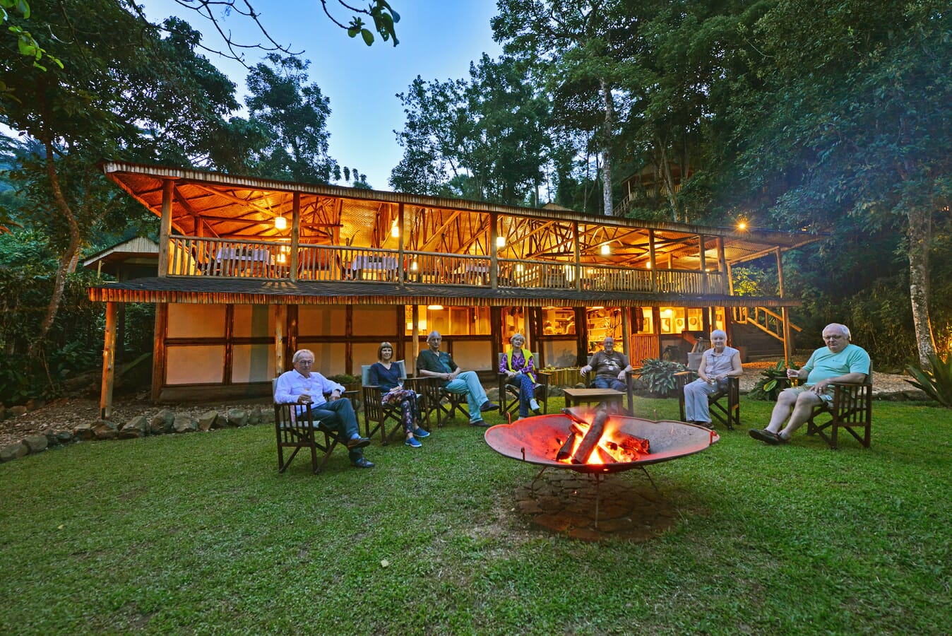 What to Pack for Kibale National Park 27 Travelers relaxing outside a forest lodge near Kibale National Park after safari activities